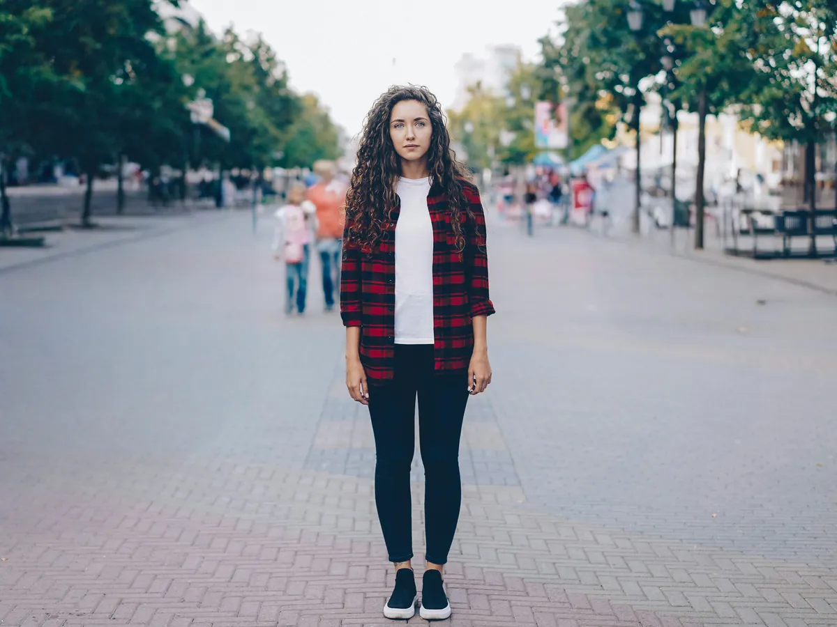 Blurred passers-by removed from behind a woman on a pedestrian street